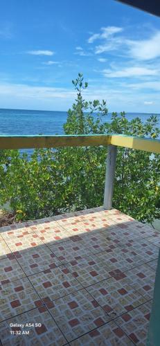 a wooden fence with the ocean in the background at Casa Mariner Resort in Good Hope