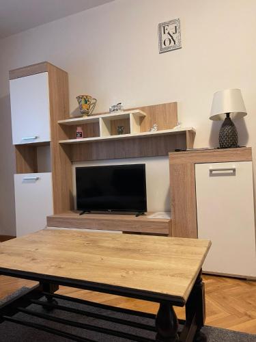 a living room with a coffee table and a television at Apartment Dada in Bjelovar