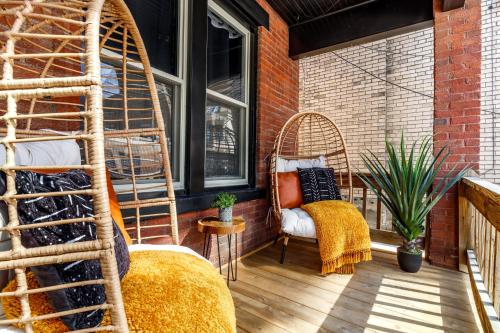 a balcony with a bed and a chair at Prime Location Top Rated Clean Parking Free! in Columbus