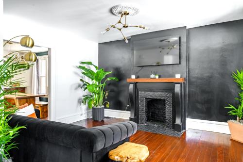 a living room with a couch and a fireplace at Prime Location Top Rated Clean Parking Free! in Columbus