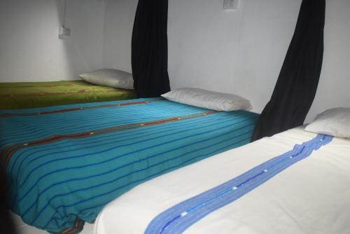 Ένα ή περισσότερα κρεβάτια σε δωμάτιο στο Hostal Antigüeño