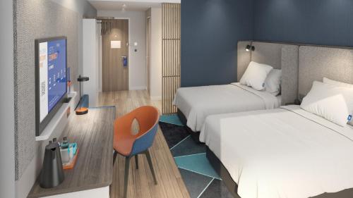 a hotel room with two beds and a tv at Holiday Inn Express Lanzhou Downtown by IHG in Lanzhou