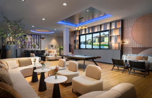 a hotel lobby with couches and a pool table at Leonardo Royal Hotel Cologne Bonn Airport in Cologne