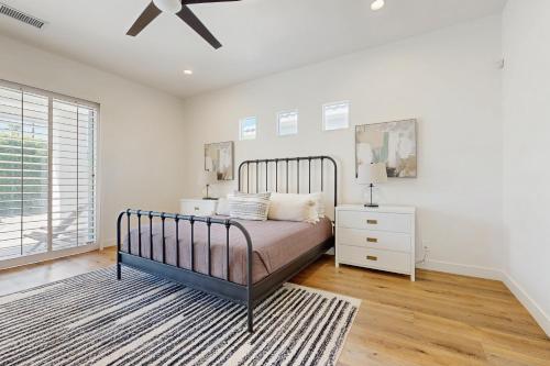 a bedroom with a bed and a ceiling fan at Casa Sereno in Palm Desert