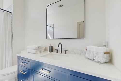 a bathroom with a sink and a mirror at Casa Sereno in Palm Desert