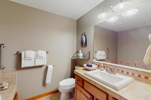 Un baño con lavabo, inodoro y espejo. en Birch Bay Getaway, en Birch Bay