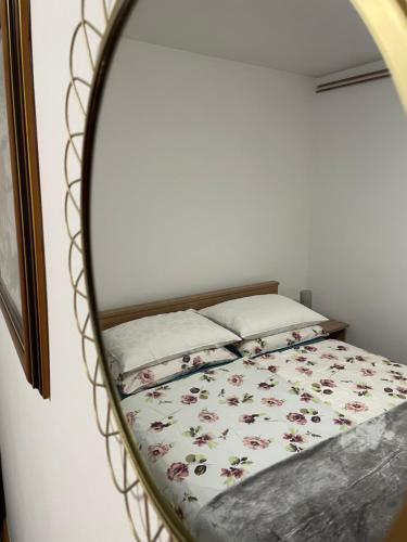 a bedroom with a bed in a mirror at Apartment Dada in Bjelovar