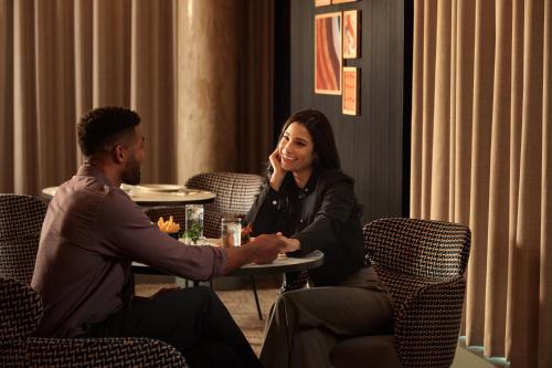 a man and a woman sitting at a table in a restaurant at Holiday Inn Chicago Midway Airport S by IHG in Chicago