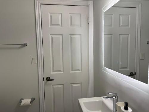 a bathroom with a white door and a sink at Spacious Home in Brampton Perfect for Families in Brampton