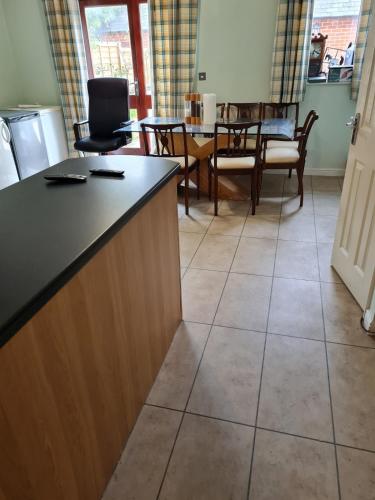 a kitchen and dining room with a table and chairs at Super king bed room A in Sherborne Saint John