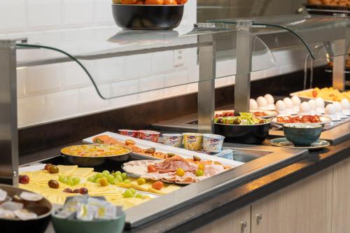 a buffet line with many different types of food at Holiday Inn Express & Suites Sion by IHG in Sion