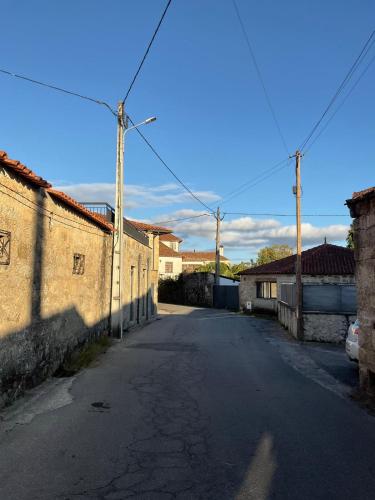 an empty street in a small town with buildings at Casa de Campo Patio do Avo in Routar