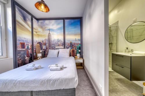 a bedroom with a large window with a city view at La Résidence Courcelles - Climatisation in Reims