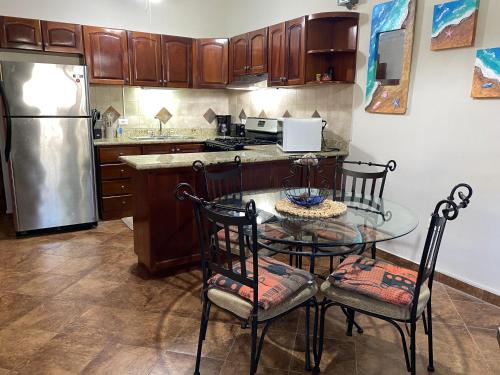 a kitchen with a table and chairs and a refrigerator at Two Bedroom Home Punta Chame Resort in Pajonal