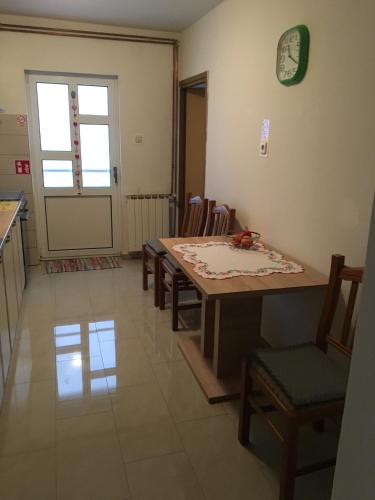 a kitchen and dining room with a table and chairs at Apartment Dada in Bjelovar