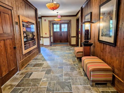 a hallway with a stone floor and wooden walls at Firefly Cove #202 in Chimney Rock