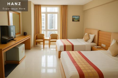 a hotel room with two beds and a television at S79 Happy 7 Ly Thai To Street in Ho Chi Minh City