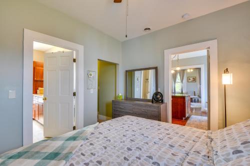 Un dormitorio con una cama, una cómoda y un espejo. en Walk to Lake and Dining Inviting Sackets Harbor Apt, en Sackets Harbor