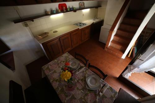 an overhead view of a kitchen with a table with a flower on it at Il Vignone - Castagneto Carducci in Castagneto Carducci