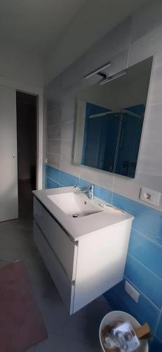 a bathroom with a white sink and a mirror at Il Nido di Chiara in Formia