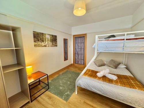 a bedroom with a bed and a bunk bed at Spacious Three Bedroom in Bournemouth - 5 Mins Walk to Beach - Free Parking in Bournemouth