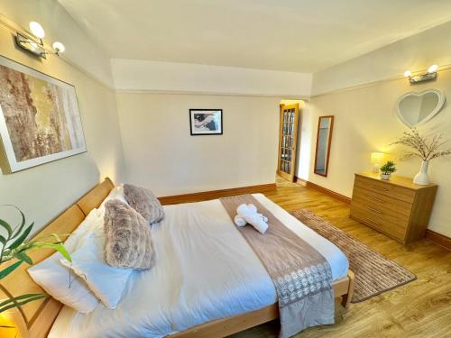 a bedroom with a bed with a teddy bear on it at Spacious Three Bedroom in Bournemouth - 5 Mins Walk to Beach - Free Parking in Bournemouth