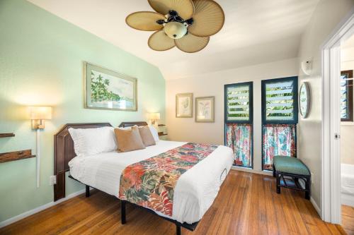 a bedroom with a bed and a ceiling fan at Kaha Lani 212 - Oceanfront 2BR Condo with Pool, Tennis & BBQs in Wailua
