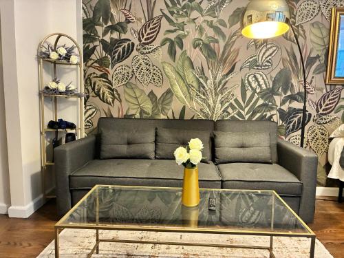 a living room with a couch and a table at West Village Lush Green in New York