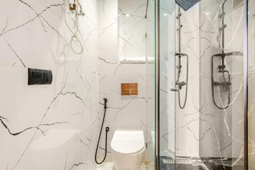 a bathroom with a toilet and a glass shower at Awesome place with city view maarif casablanca in Maarif