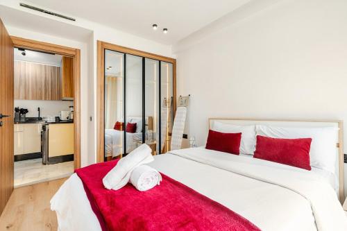 a bedroom with a large white bed with red pillows at Awesome place with city view maarif casablanca in Maarif