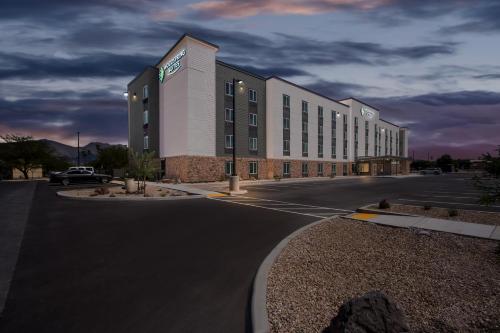 a large building with a parking lot in front of it at WoodSpring Suites Tucson Medical Center in Tucson