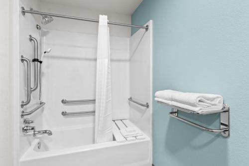 a bathroom with a shower with a shower curtain at WoodSpring Suites Tucson Medical Center in Tucson