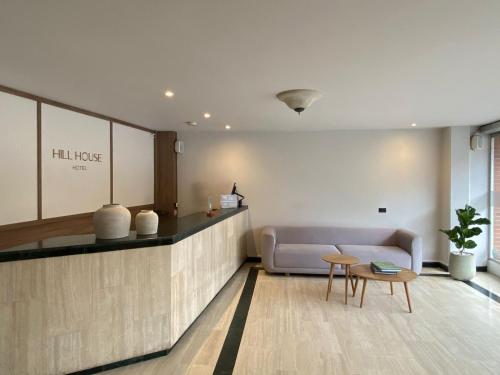 a living room with a couch and a table at Hotel Hill House Usaquén in Bogotá