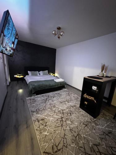 a bedroom with a bed and a flat screen tv at Cozy Home Studio in Petroşani