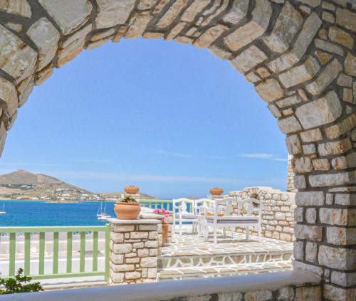 a view of the ocean through a stone archway at Villa Isabella in Naousa