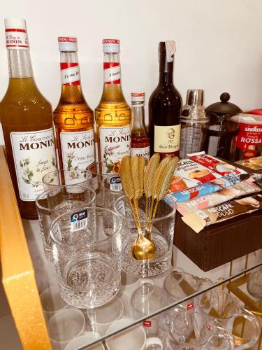 a group of bottles of alcohol and glasses on a counter at A New Cozy Residential With Garden For Rent In Degla Palms Compound, 6th of Octobe in 6th Of October