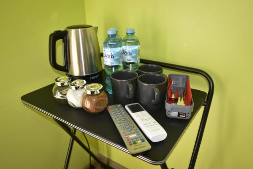 a black table with a coffee maker and a remote control at Pokoje Mira in Torzym