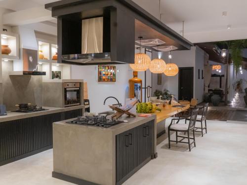 a kitchen with a stove and a counter top at D' Art VILLA RETREAT AND SPA in Tangalle