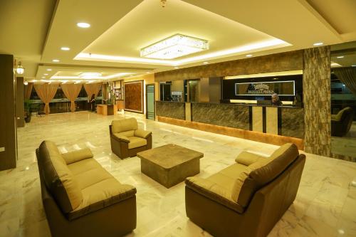 a lobby with two couches and a coffee table at Hotel Anika Kluang in Kluang