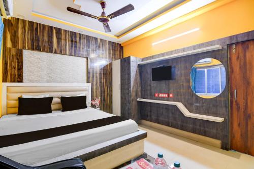a bedroom with a bed and a tv at Hotel O subharaj palace and restaurant in Kalyani