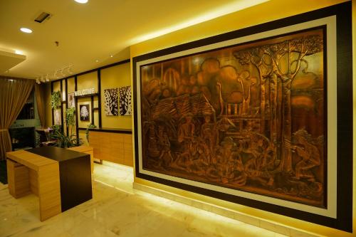 a large painting on the wall in a room at Hotel Anika Kluang in Kluang