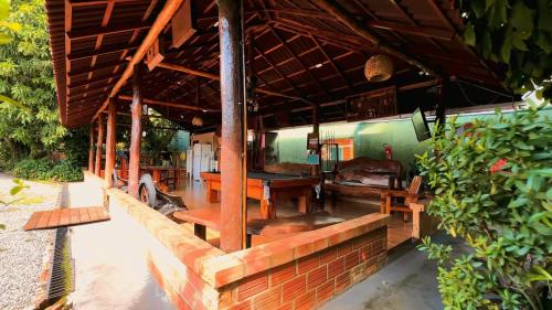 a building with wooden tables and benches on it at Hotel Borari in Alter do Chao