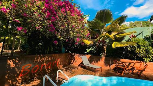 a resort with a swimming pool and pink flowers at Hotel Borari in Alter do Chao