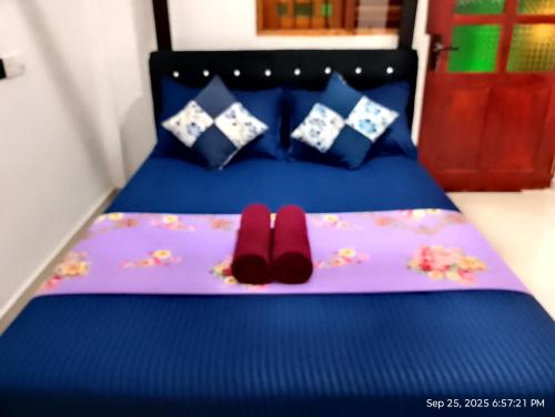 a bed with two red slippers on it at Yala Eagle Nest in Tissamaharama