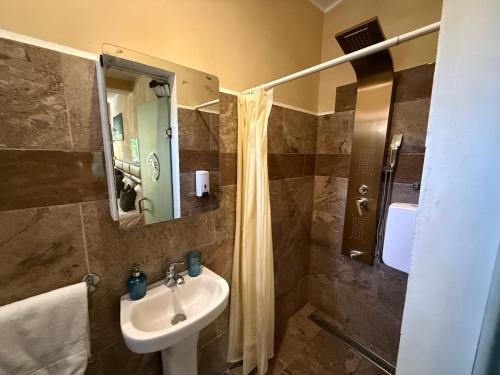 a bathroom with a sink and a shower at Sosua Inn Hotel in Sosúa