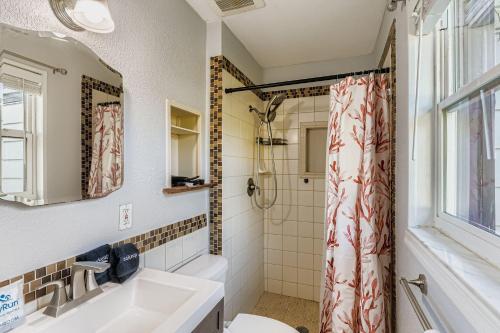 a bathroom with a sink and a shower at Cozy Patio Retreat by SkyRun Jacksonville in Sandalwood
