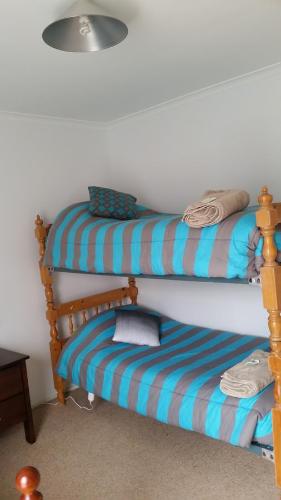 a room with two bunk beds and a ottoman at The Quorn-er House in Quorn