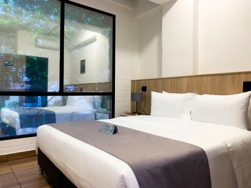 Llit o llits en una habitació de Hotel Provenza Garden