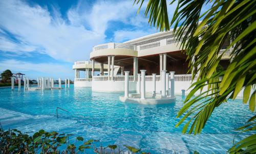 a swimming pool in front of a building at Grand Palladium Lady Hamilton Resort & Spa - All Inclusive in Lucea