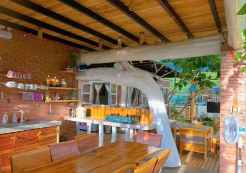 a dining room with a table and a kitchen at Đà Lạt in Phú Quốc Homestay - Free Airport Pickup for 4 night bookings in Phu Quoc